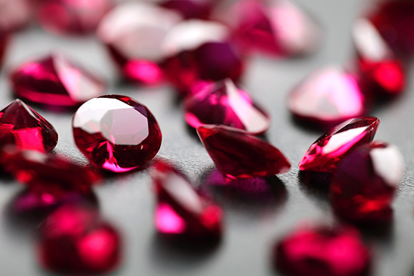 Various-sized rubies on a dark surface